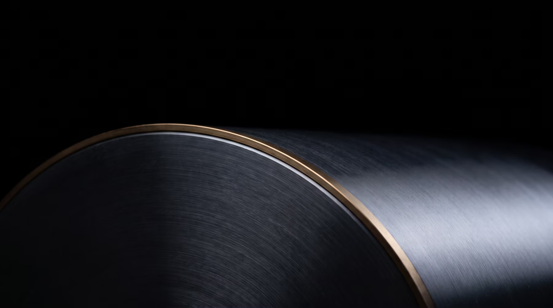 Large dark curved structure edged in brass representing coordinated scale