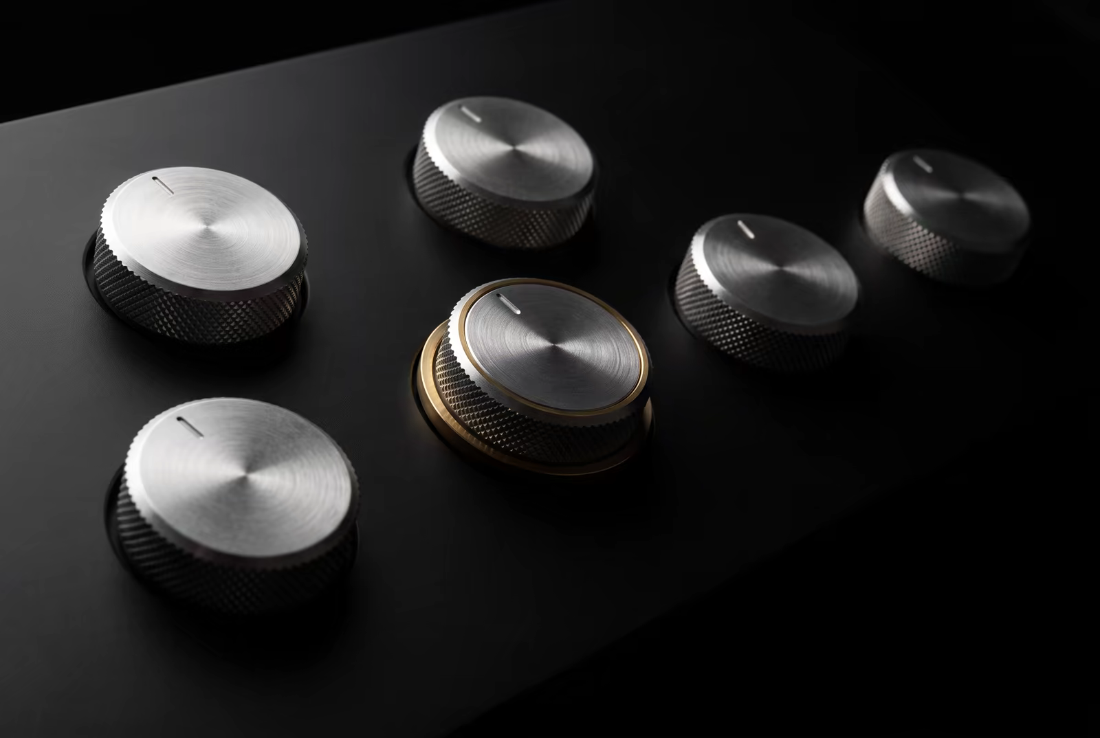 Precision control dials with a central gold-accented control representing measured expansion